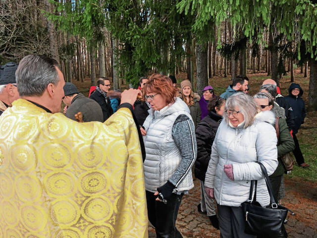 610211_web1_Joyce-Eger-receives-blessing-of-the-Holy-Water