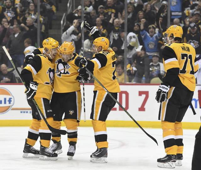 Penguins center Teddy Blueger (53) celebrates with right wing Phil Kessel  (81) after Blueger scored a goal, his second of the night, during the third  period of an NHL hockey game against