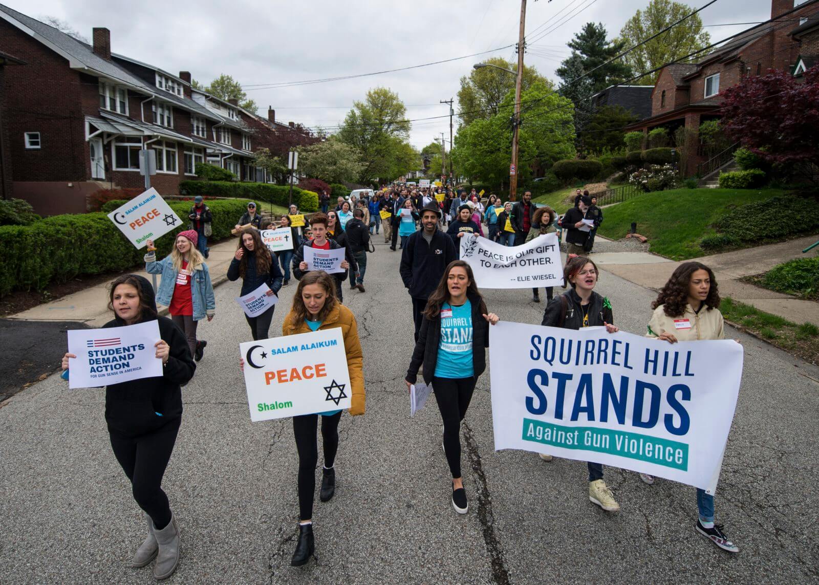 Community members march to a tree planting in Schenley Park on April 28, the six-month anniversary of the Tree of Life shooting.
