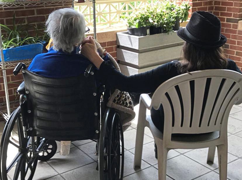 Evelyn Klimovich, 93, (left) sits on the terrace with her daughter, JoAnne Klimovich Harrop, 57, at Charles Morris Nursing and Rehabilitation Center in Squirrel Hill.