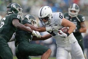 Penn States Pat Freiermuth, right, pushes past Michigan States Xavier Henderson (3) and David Dowell (6) for a touchdown during the second quarter of an NCAA college football game, Saturday, Oct. 26, 2019, in East Lansing, Mich.