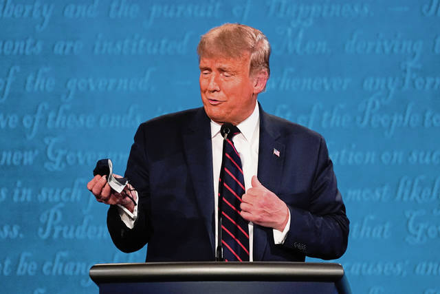 4048648_web1_Trump_holding_Mask
