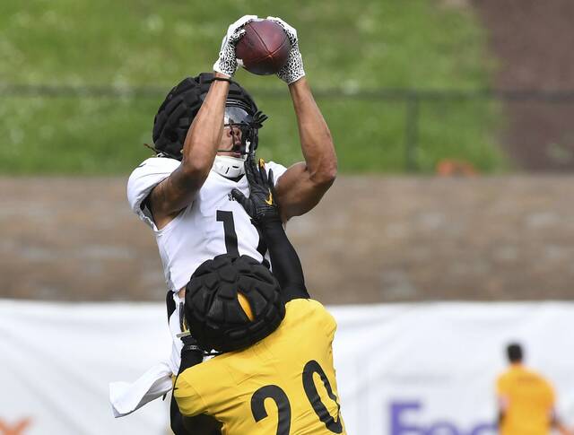 Steelers receiver Chase Claypool elevates over corner back Cameron Sutton during practice Tuesday, Aug. 16, 2022 at Saint Vincent College.