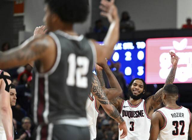 Duquesne’s Dae Dae Grant celebrates hitting a three-pointer Nov. 8 and being fouled on the play by Montana’s Brandon Whitney at UPMC Cooper Fieldhouse.