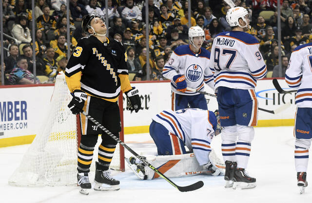 Edmonton Oilers right wing Kailer Yamamoto (56) is greeted by his teammates  after scoring on Pittsburgh Penguins goalie Tristan Jarry during the second  period of an NHL hockey game, Thursday, Feb. 23