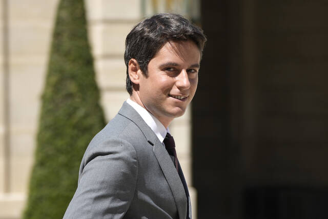 Government spokesperson Gabriel Attal walks out after a weekly cabinet meeting May 11, 2022, at the Elysee Palace, in Paris.