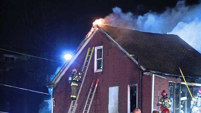 Firefighters battle a blaze Tuesday morning at a Shaler home along Beyrleye Avenue.