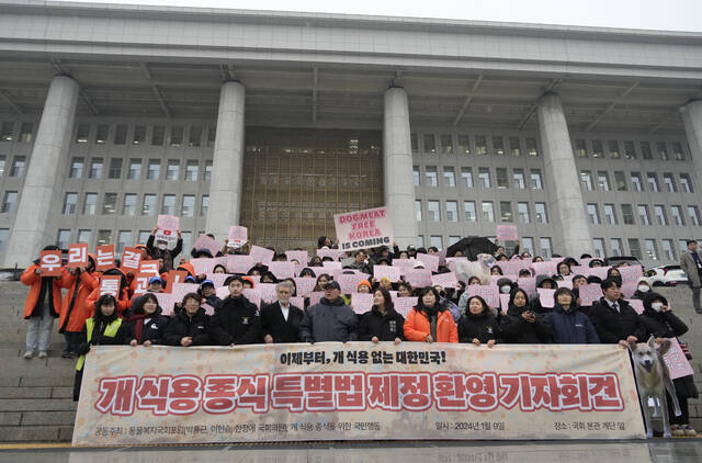 Animal rights activists attend a protest rally supporting the government-led dog meat banning bill at the National Assembly in Seoul, South Korea, Tuesday, Jan. 9, 2024.