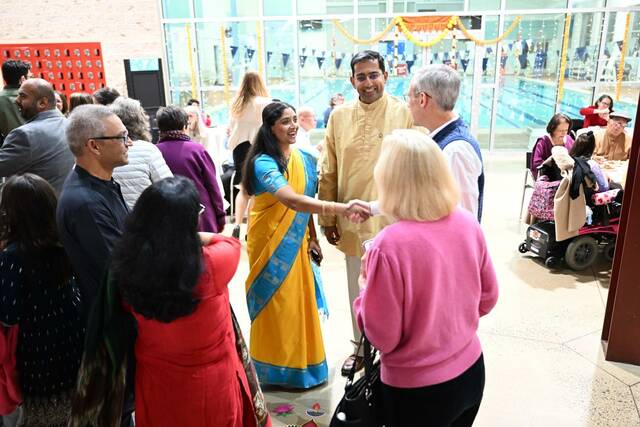 9013145_web1_venkat-and-wife-greet-guests