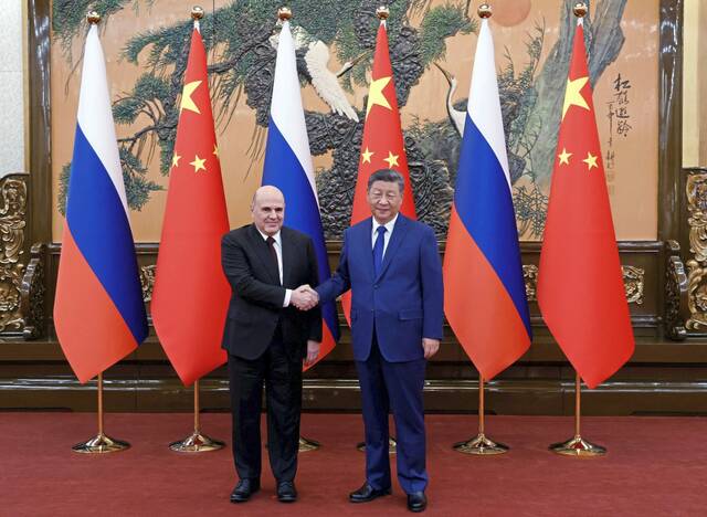 China, Russia vow joint response to 'unilateral' sanctions during Russian PM visit