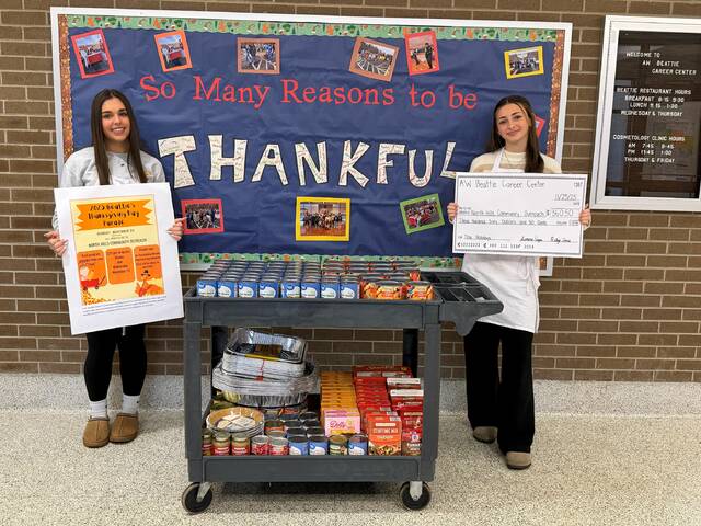 9080816_web1_naj-BeattieCheckHolding-121125