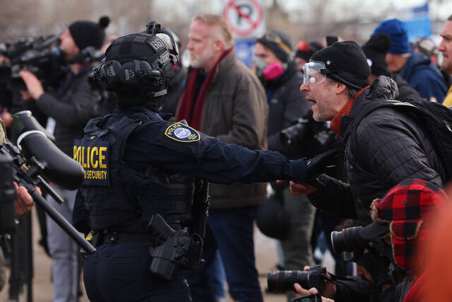 Protesters confront law enforcement outside the Bishop Henry Whipple Federal Building in Minneapolis, Friday, Jan. 9, 2026. (AP)