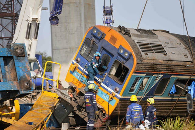 A construction crane falls onto a moving train in Thailand, killing at least 32 people