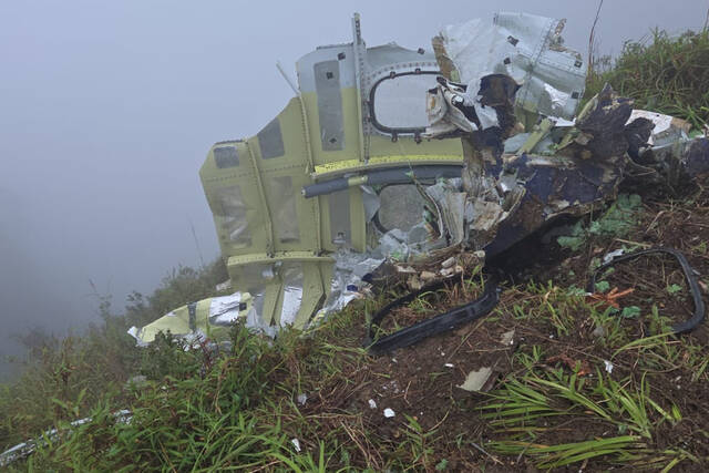 Indonesian rescuers find a body near wreckage of a plane that crashed with 11 aboard