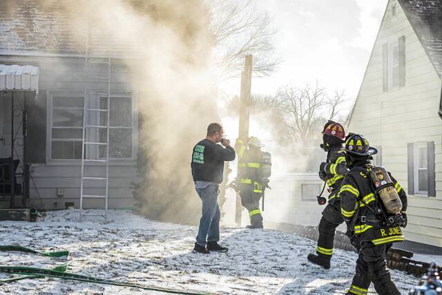 Woman escapes injury in Harrison house fire