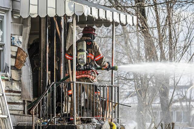 Woman escapes injury in Harrison house fire