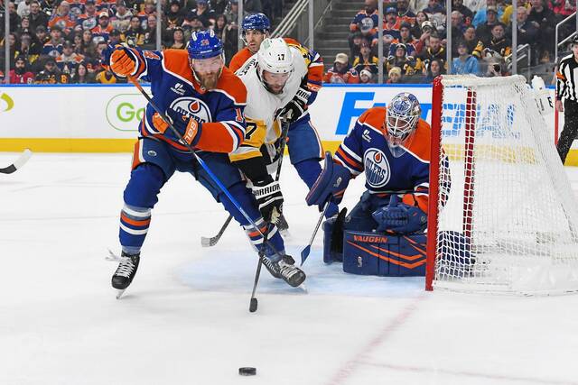 
			
				                                Mattias Ekholm of the Edmonton Oilers battles for the puck against Bryan Rust of the Pittsburgh Penguins during the first period at Rogers Place on Jan. 22, 2026, in Edmonton, Alberta. (Getty Images)

			
		