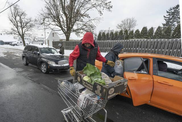 Volunteers face cold, snow to help local food banks