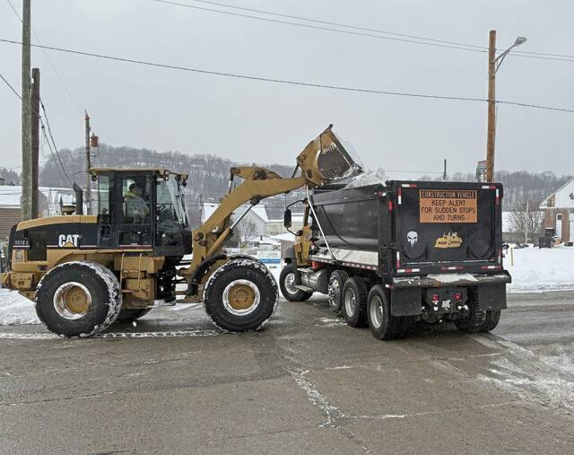 Business owners and road crews work in tandem to preserve street parking after storm