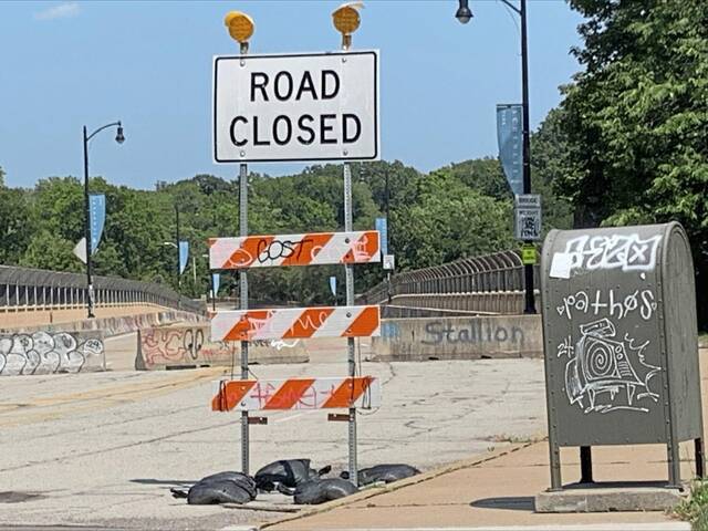 A Road Closed sign and several cement Jersey barriers block motorists from entering Charles Anderson Memorial Bridge in Pittsburghs South Oakland neighborhood on Sunday, July 28, 2024. (Justin Vellucci | TribLive)