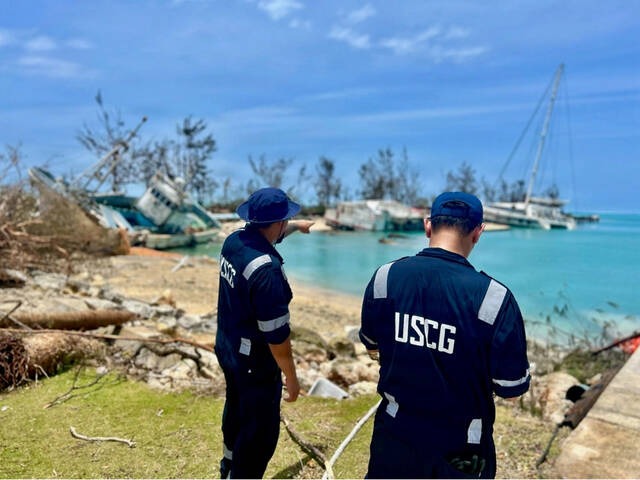Searchers find the body of 1 of 6 missing crew from a ship that overturned during a typhoon