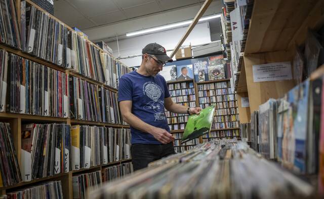 
			
				                                Chris Grauzer, owner of Jerry's Records, looks through vinyl records at his shop in Squirrel Hill on Tuesday, April 14, 2026. (Massoud Hossaini | TribLive)

			
		
