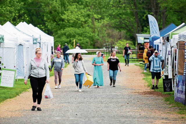 
			
				                                Market shoppers browse vendors in the rain during the Ligonier Country Market on as the market opens for the season on Saturday, May 20, 2023, in Ligonier Township. (Shane Dunlap | TribLive)

			
		