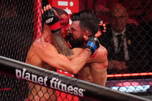 Mike Perry bloodies and beats Nate Diaz in 2 rounds on Rousey-Carano undercard