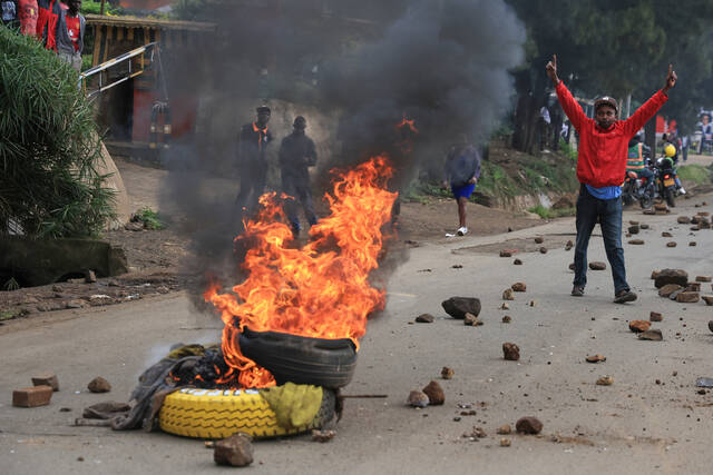 Protesters light bonfires during public transport strike in Kenya over fuel prices