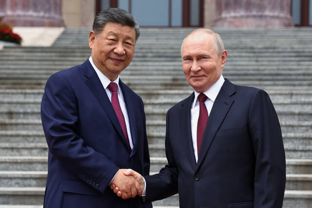 Putin and Xi hail their friendship and growing energy trade at their meeting in Beijing