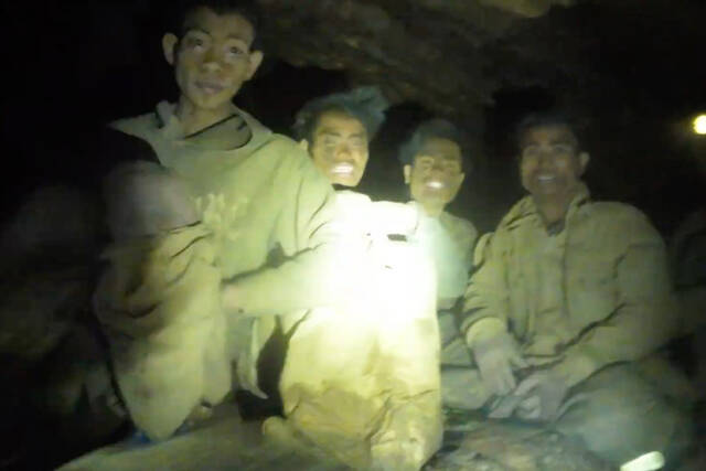 Rescuers evacuate 1st of 5 villagers found trapped in a cave in Laos; 2 still missing